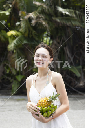 Woman with pineapple and banana 129343505