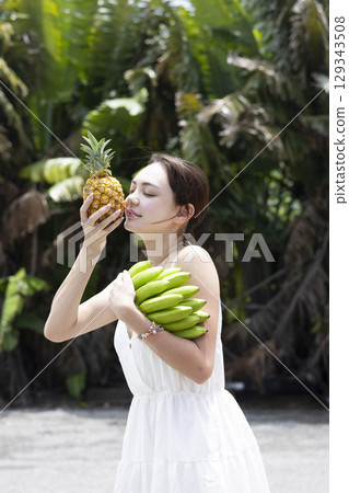 Woman with pineapple and banana Woman with pineapple and banana 129343508