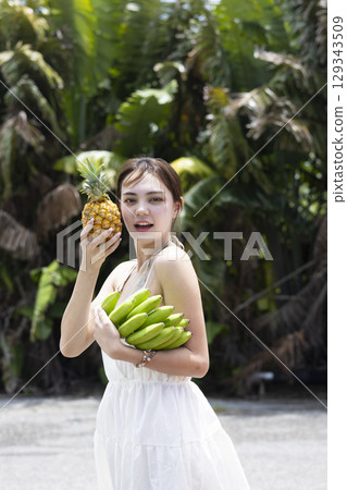 Woman with pineapple and banana Woman with pineapple and banana 129343509