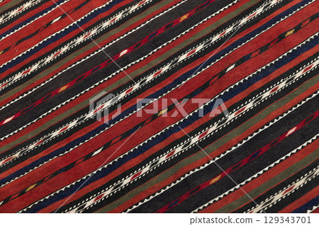 Vividly Patterned Fabric Depicting Traditional Stripes and Intricate Geometric Motifs 129343701