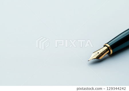 Elegant fountain pen poised on pristine white surface during a creative writing session 129344242