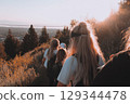 Group hike for mental health awareness, teens descending from hill, 129344478
