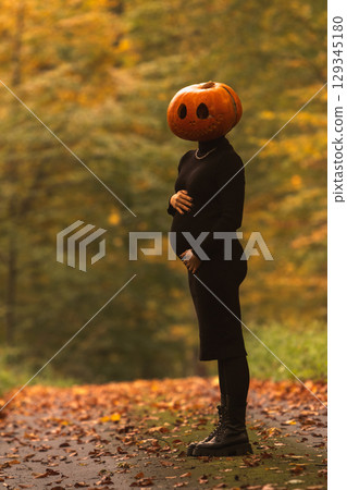 Surreal Autumn Scene with Pumpkin Head 129345180