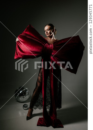 Elegant Woman in Dramatic Red Bow Dress with Confidence Elegant Woman in Dramatic Red Bow Dress with Confidence 129345771