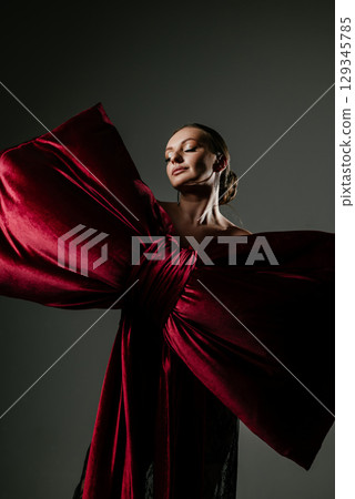 Elegant Woman Posed with Large Red Velvet Bow Elegant Woman Posed with Large Red Velvet Bow 129345785