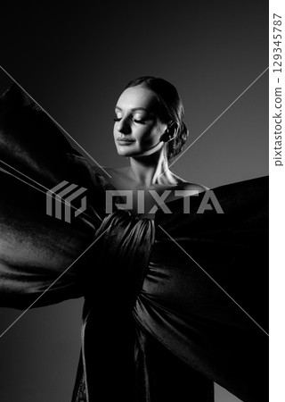 Elegant Woman in Dramatic Black and White Gown 129345787
