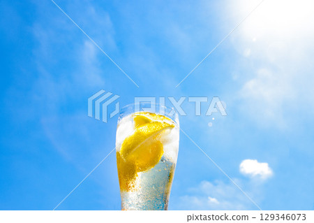 Blue sky and a glass of lemon carbonated drink Blue sky and a glass of lemon carbonated drink 129346073