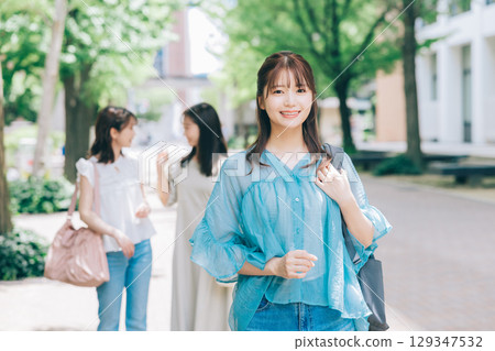 Female college student walking inside the university 129347532