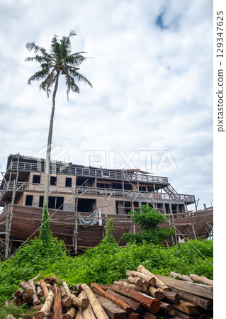 Traditional wooden boat under construction in Tana Beru, Indonesia Traditional wooden boat under construction in Tana Beru, Indonesia 129347625