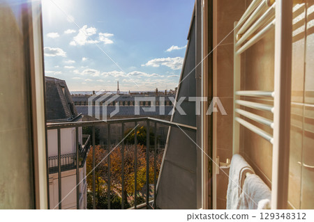 View from the open window of the city of Paris rooftops and Eiffel Tower. Paris, France 129348312