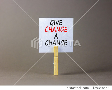 Give change a chance symbol. Concept words phrase Give change a chance on beautiful white paper on clothespin. Beautiful grey paper background. Business Give change a chance concept. Copy space. 129348338