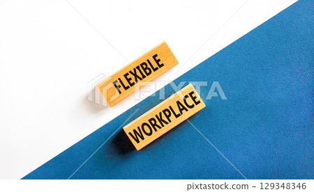 Flexible workplace symbol. Concept words Flexible workplace on beautiful wooden block. Beautiful blue and white paper background. Business Flexible workplace concept. Copy space. 129348346
