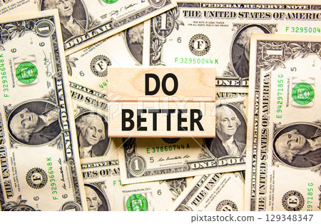Do better symbol. Concept words Do better on beautiful wooden blocks. Dollar bills. Beautiful background from dollar bills. Business and do better concept. Copy space. 129348347
