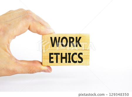 Work ethics symbol. Concept words Work ethics on beautiful wooden block. Beautiful white table white background. Businessman hand. Business and Work ethics concept. Copy space. 129348350