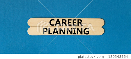 Career planning symbol. Concept words Career planning on wooden stick. Beautiful blue table blue background. Business, motivational career planning concept. Copy space. 129348364