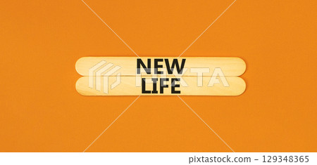 New life symbol. Concept words New life on beautiful wooden stick on a beautiful orange table orange background. Business, support, motivation, psychological and new life concept. Copy space. New life symbol. Concept words New life on beautiful wooden stick on a beautiful orange table orange background. Business, support, motivation, psychological and new life concept. Copy space. 129348365