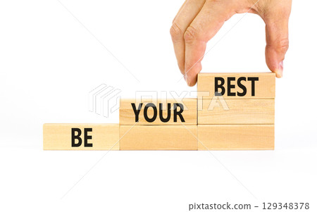 Motivational be your best symbol. Concept words Be your best on beautiful wooden blocks. Beautiful white table white background. Businessman hand. Business motivational be your best concept Copy space Motivational be your best symbol. Concept words Be your best on beautiful wooden blocks. Beautiful white table white background. Businessman hand. Business motivational be your best concept Copy space 129348378