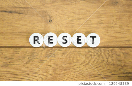 Reset symbol. Concept word Reset on beautiful white pills circles. Beautiful wooden table wooden background. Business lifestyle reset concept. Copy space. Reset symbol. Concept word Reset on beautiful white pills circles. Beautiful wooden table wooden background. Business lifestyle reset concept. Copy space. 129348389