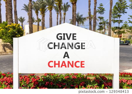 Give change a chance symbol. Concept words phrase Give change a chance on beautiful big white road sign. Beautiful palm tree blue sky background. Business Give change a chance concept. Copy space. Give change a chance symbol. Concept words phrase Give change a chance on beautiful big white road sign. Beautiful palm tree blue sky background. Business Give change a chance concept. Copy space. 129348413