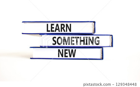Learn something new symbol. Concept words Learn something new on beautiful books. Beautiful white paper background. Business motivational lifestyle learn something new concept. Copy space. 129348448
