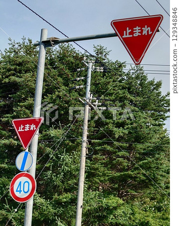 A stop sign at an intersection without traffic lights (vertical photo) 129348846