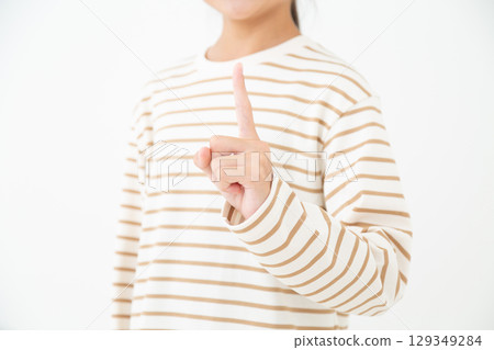 A middle school girl pointing her index finger A middle school girl pointing her index finger 129349284