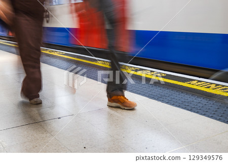 Commuters in Motion on London Underground Platform, Mind the Gap and Passing Tube 129349576