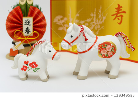 A mother and baby white horse celebrating the New Year and gorgeous New Year decorations 129349583
