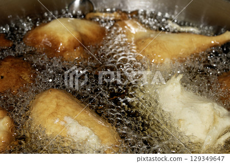 Close up of frying batter in oil chicken balls home made 129349647