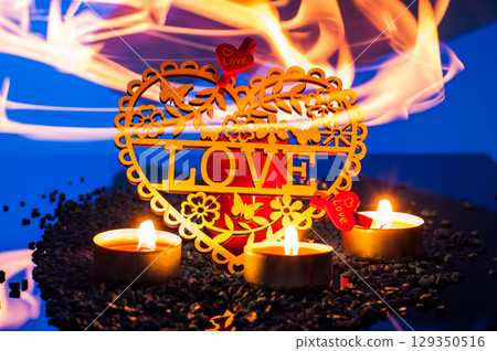 Candles flicker on a background of colorful shimmer, surrounding everything with a romantic glow. Candles flicker on a background of colorful shimmer, surrounding everything with a romantic glow. 129350516