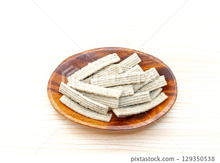 Calcium-rich, vitamin D-rich sardine snacks served on a wooden plate 129350538