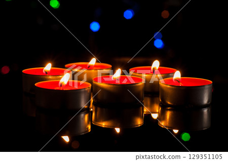 Countless small candles gently flicker in the deep darkness Countless small candles gently flicker in the deep darkness 129351105