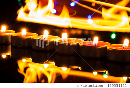 Countless small candles gently flicker in the deep darkness Countless small candles gently flicker in the deep darkness 129351111