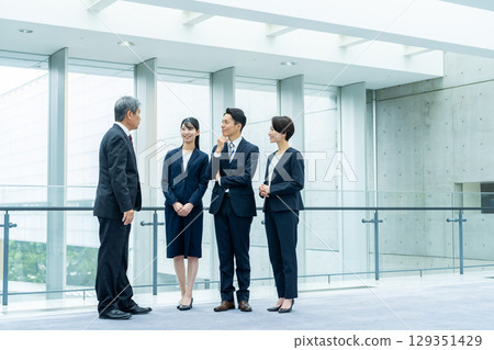 business person standing in lobby 129351429