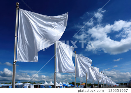 Flags fluttering along a vibrant parade route under clear sky 129351967