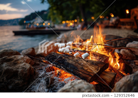 Campfire gathering at the beach on a summer evening Campfire gathering at the beach on a summer evening 129352646