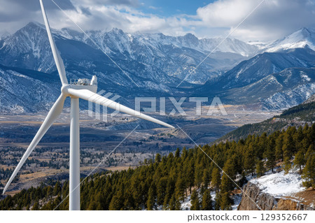 Close-up of wind turbine with mountains in bright daylight 129352667