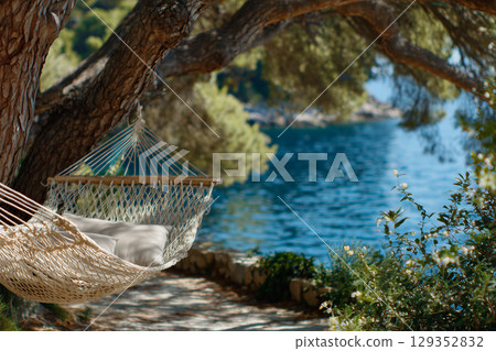 Hammock between pine trees overlooking the Adriatic Sea Hammock between pine trees overlooking the Adriatic Sea 129352832