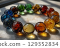 Translucent spheres create rainbow shadows in spiral arrangement 129352834