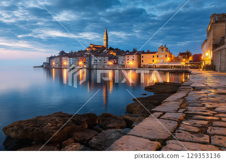 Colorful seaside town in Croatia glows at dusk 129353136
