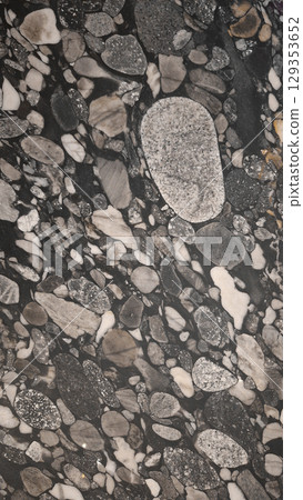 Close-up view of polished natural stone with various shapes and textures 129353652