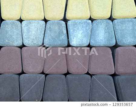 Colorful assortment of interlocking concrete pavers in rectangular pattern 129353657