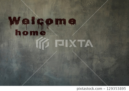 Art shabby grey plastered wall with bloody inscription welcome home, copy space. 129353895