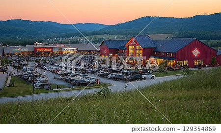 Scenic mountainside shopping center with red barn style buildings Scenic mountainside shopping center with red barn style buildings 129354869