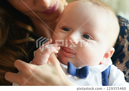 Young mother with her baby son, detail on heads close together, as she's about to kiss him on head Young mother with her baby son, detail on heads close together, as she's about to kiss him on head 129355460