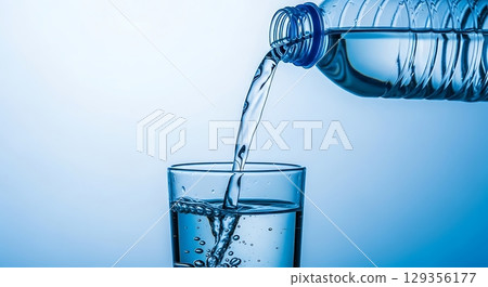 water splash in glass isolated on white 129356177