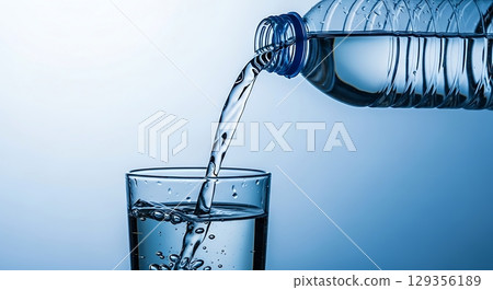 water splash in glass isolated on white 129356189