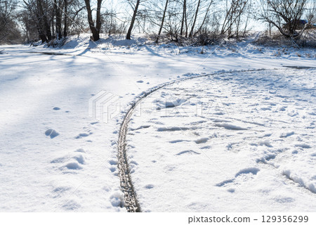 Giant ice circle spins on river in winter. A rare phenomenon of giant ice circle rotating in the river 129356299