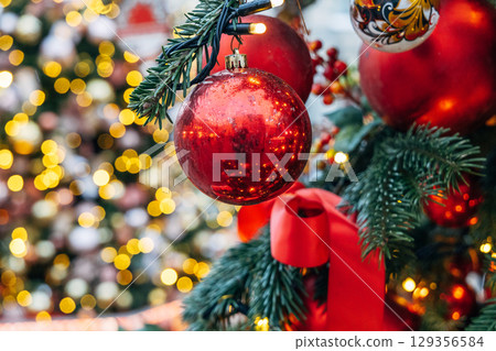 New Year's colorful trees in front of the Central Department Store in Moscow on Kuznetsky Most 129356584