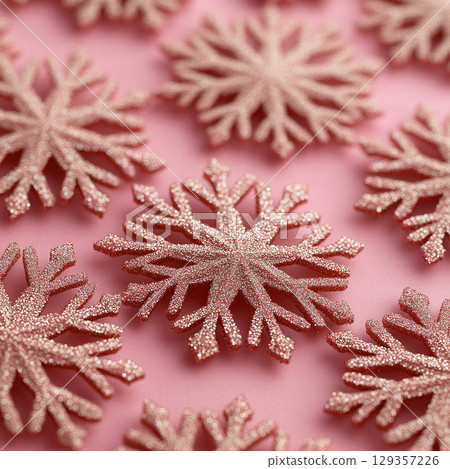 Merry Christmas, Happy New Year. Pink background golden white Christmas snowflakes close up 129357226